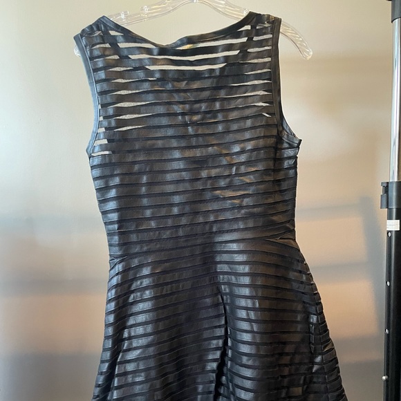 Black sleeveless dress. Falls above the knee on me (5’7) - Picture 2 of 3